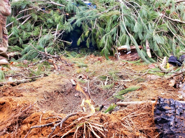 Students in Cold-Weather Operations Course class 21-05 conduct field training with improvised shelters, including with the one shown here, March 16, 2021, at a training area at Fort McCoy, Wis. CWOC students are trained on a variety of...