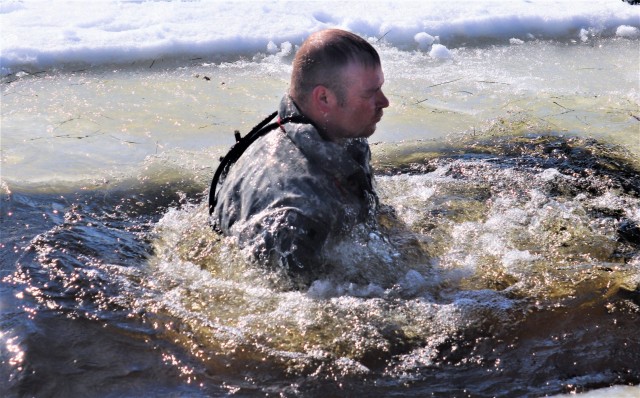 A Fort McCoy Cold-Weather Operations Course (CWOC) Class 21-04 student participates in cold-water immersion training Feb. 26, 2021, at Big Sandy Lake on South Post at Fort McCoy, Wis. CWOC students are trained on a variety of cold-weather...