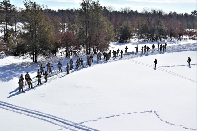 Students in Cold-Weather Operations Course class 21-04 complete field training pulling ahkio sleds of equipment on snowshoes Feb. 18, 2021, at a training area at Fort McCoy, Wis. Students complete many miles of ruck marching in the snow and cold...