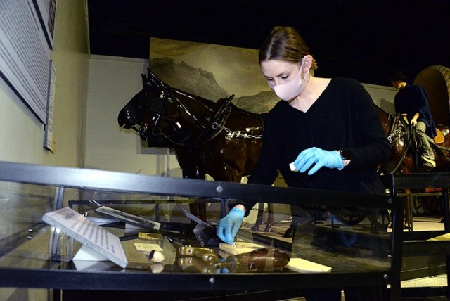 Fayelee Overman, museum technician, places circa 1864 percussion caps in the "19th Century Female Soldiers" exhibit March 11 at the Frontier Army Museum. The exhibit features information about women disguising themselves as men to serve in the...