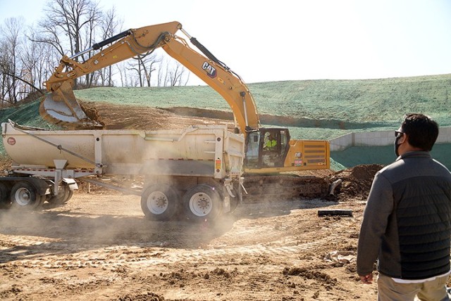 Chris Fernandez, Directorate of Plans, Training, Mobilization and Security operations and training specialist, right, watches Joey Noll, superintendent for Julius Kaaz Construction Company, use an excavator to load parts of an old storm sewer for...