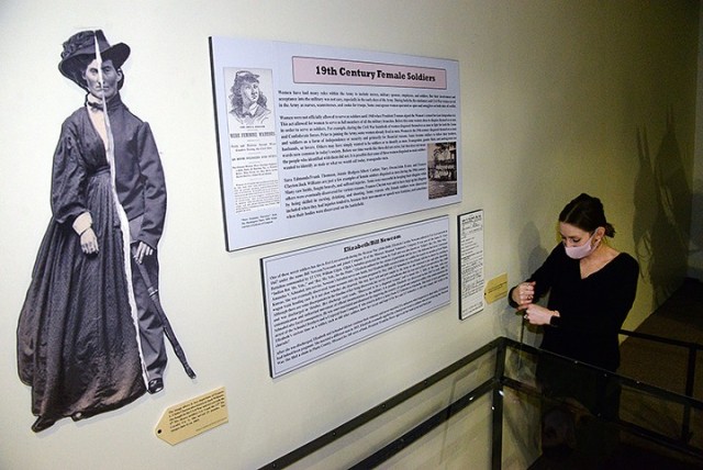 Fayelee Overman, museum technician, prepares a display case to hold information and artifacts as she assembles the "19th Century Female Soldiers" exhibit March 11 at the Frontier Army Museum. The exhibit features information about women disguising...