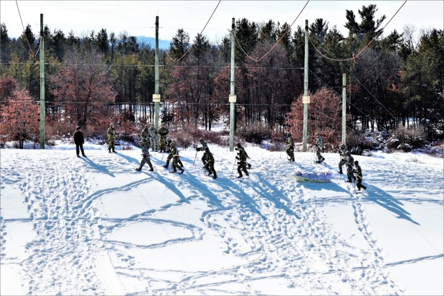 Students in Cold-Weather Operations Course class 21-04 complete field training pulling ahkio sleds of equipment on snowshoes Feb. 18, 2021, at a training area at Fort McCoy, Wis. Students complete many miles of ruck marching in the snow and cold...