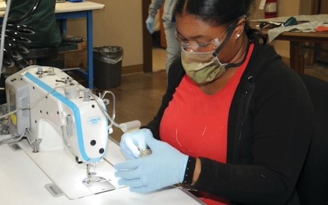 An employee at Pine Bluff Arsenal, a Joint Munitions Command subordinate installation, produces face coverings during Covid-19 response.  