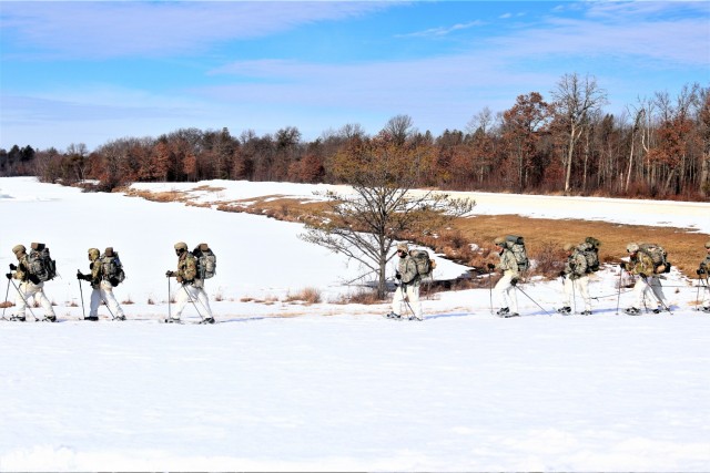 Students in Cold-Weather Operations Course class 21-04 complete field training pulling ahkio sleds of equipment on snowshoes Feb. 26, 2021, at a training area at Fort McCoy, Wis. Students complete many miles of ruck marching in the snow and cold...