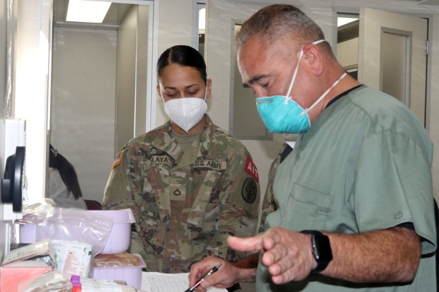 A Soldier in the advanced individual training phase (AIT), watches as a laboratory technician with the Armed Services Blood Program explains the steps for a blood donation during a blood drive on Fort Bliss, Texas, May 16, 2021. The event provided an experienced training environment for service members training to become laboratory technicians in the AIT phase on Fort Bliss. Blood drives are important because they provide quality blood products for service members, veterans and their families in both peace and war. For 5th AR BDE, preparing Soldiers to go into harm’s way isn’t merely a cold, mechanical process; rather, it’s a dedication to individuals’ strengths and needs, focused on achieving the mission. (U.S. Army photo by Staff Sgt. John Onuoha, 5th Armored Brigade)