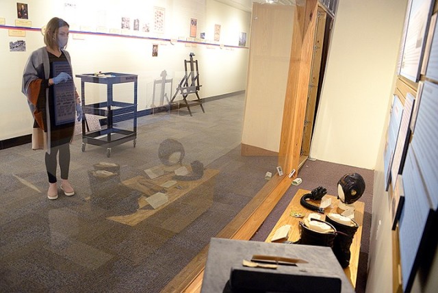 Fayelee Overman, museum technician, surveys an aviation exhibit as she arranges items and information panels for display Jan. 27 at the Frontier Army Museum. Photo by Prudence Siebert/Fort Leavenworth Lamp