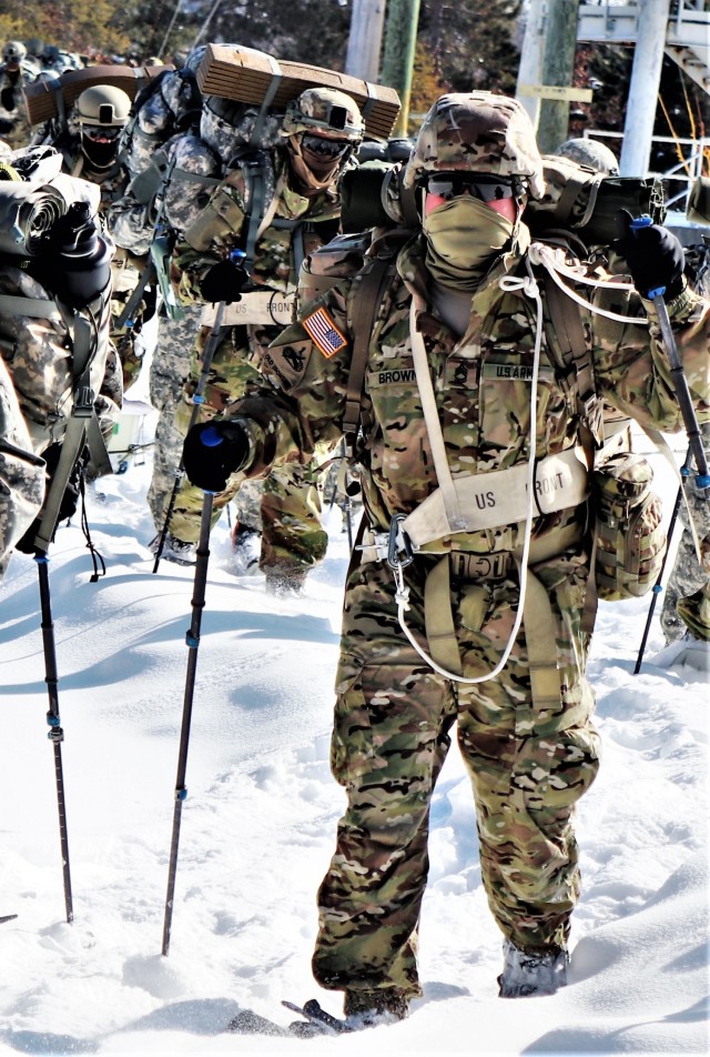 Students in Cold-Weather Operations Course class 21-04 complete field training pulling ahkio sleds of equipment on snowshoes Feb. 18, 2021, at a training area at Fort McCoy, Wis. Students complete many miles of ruck marching in the snow and cold...