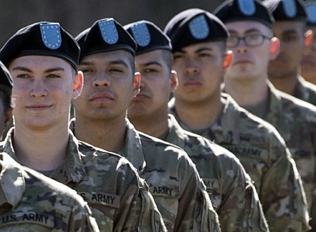 Pvt. Kenny Oliver (second from the left), a trainee with 1st Battalion, 34th Infantry Regiment, stands in formation during his unit's graduation ceremony March 11 at Hilton Field on Fort Jackson. Oliver, who will be going to Advanced Individual...