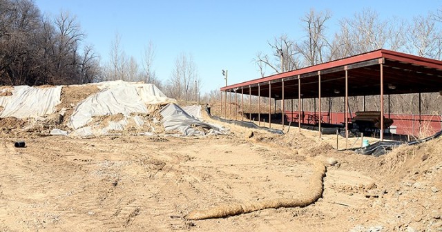 Tarps cover lead-contaminated soil, which was removed while extending Kinder Range to 50 meters and is awaiting proper disposal. When complete, the extended range will have a concrete pad from the firing line to the target area to provide good...