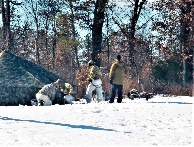 Students in Cold-Weather Operations Course class 21-04 participate in a training scenario Feb. 26, 2021, at a South Post training area at Fort McCoy, Wis. Students complete many miles of ruck marching in the snow and cold during the course....
