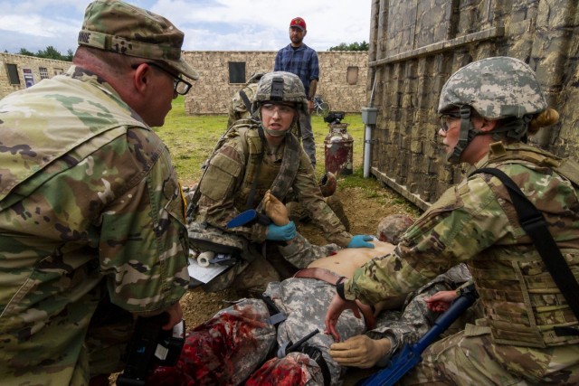 U.S. Army Reserve Sgt. Christian Rennie, left, an instructor-operator with the Fort McCoy Medical Simulation Training Center, mentors Cpt. Sean Flanagan, center, and Spc. Alexandra Vanoverbeke, Soldiers from the 13th Psychological Operations...