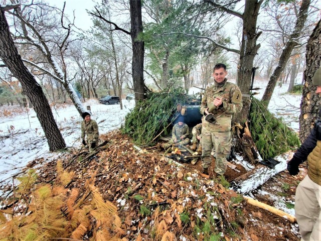 Students in Cold-Weather Operations Course class 21-05 conduct field training with improvised shelters March 16, 2021, at a training area at Fort McCoy, Wis. CWOC students are trained on a variety of cold-weather subjects, including snowshoe...