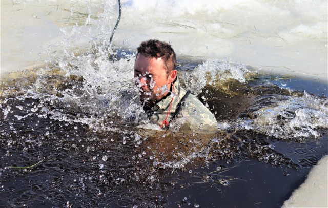 A Fort McCoy Cold-Weather Operations Course (CWOC) Class 21-04 student participates in cold-water immersion training Feb. 26, 2021, at Big Sandy Lake on South Post at Fort McCoy, Wis. CWOC students are trained on a variety of cold-weather...