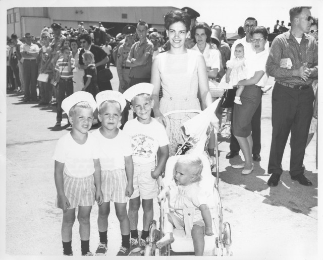 An Army wife takes her children to the 1963 Fort Knox Armed Forces Day celebration. Throughout history, military wives have created community together, often when husbands were away at war.