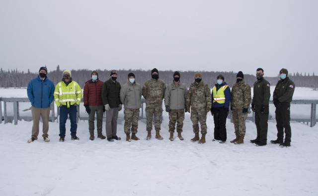 Maj. Gen. William Graham, deputy commanding general of civil and emergency operations for the U.S. Army Corps of Engineers (sixth from left), stands on the control works of the Moose Creek Dam with representatives of the Chena River Lakes Flood...
