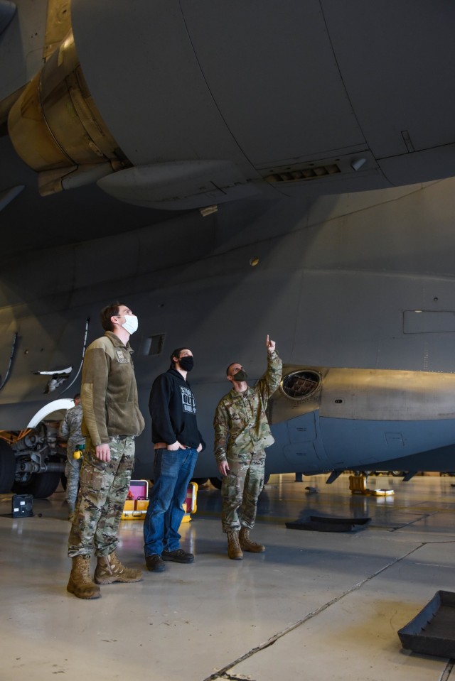 U.S. Air Force Airman 1st Class Jesse Wayland, left, Robert Hadwin, second from left, 62nd Aircraft Maintenance Squadron crew chiefs, and U.S. Air Force Master Sgt. Timothy Nonn, 62nd Maintenance Squadron production superintendent, right, identify a part issue on the engine of a C-17 Globemaster III, at Joint Base Lewis-McChord, Washington, March 11, 2021. As a maintenance squadron production superintendent, Nonn interacts with hundreds of Airmen across several different maintenance specialties to ensure necessary work gets done on JBLM’s 40 C-17 Globemaster III aircrafts. (U.S. Air Force photo by Senior Airman Mikayla Heineck)