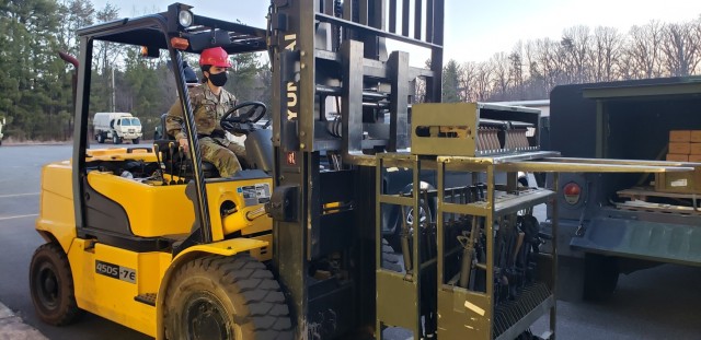 Army Spc. Keylin Jasmin Perez moves weapons after a range March 3, 2021, at Fort George G. Meade, Maryland. Perez is a supply specialist with the 200th Military Police Command as well as a nursing student and cheerleader at Coppin State University...