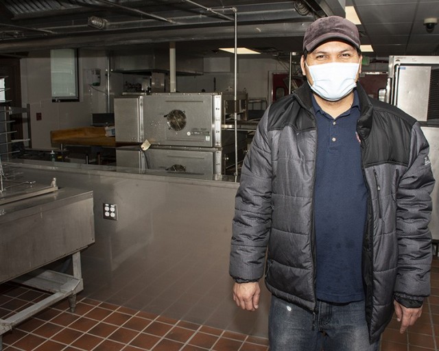 Jinky Tulabot, food and beverage manager, radiates a smile through his mask as he stands in the newly renovated kitchen at the Community Club. After being closed two years for renovation, the club reopened March 8, 2021....