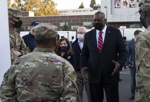 Secretary of Defense Lloyd J. Austin III speaks with soldiers from the 4th Infantry Division, Fort Carson Colo., during his visit to the visit to the first state-run, federally-supported, COVID Community Vaccination Center at California State University Los Angeles Feb. 24, 2021. U.S. Northern Command, through U.S. Army North, remains committed to providing continued, flexible Department of Defense support to the Federal Emergency Management Agency as part of the whole-of-government response to COVID-19. (U.S. Army photo by Pfc. Garrison Waites/5th Mobile Public Affairs Detachment)