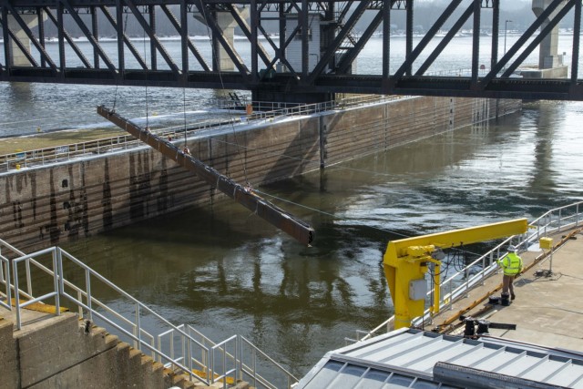 A 350-ton crane swings the underwater Acoustic Deterrent System weldment, which includes speakers for emitting sounds specific to the hearing range of invasive Asian carp, into place at Lock and Dam 19 on the Mississippi River. The weldment was...
