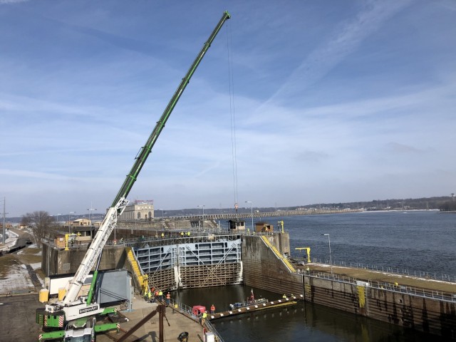The U.S. Geological Survey, the U.S. Army Engineer Research and Development Center's Environmental Laboratory and partners use a 350-ton crane to install the underwater Acoustic Deterrent System weldment at Lock and Dam 19 on the Mississippi River...