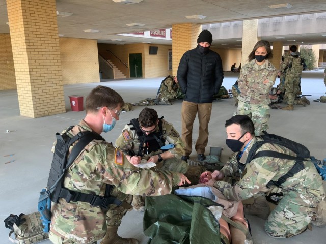 Maj. Maj. Charisse Gonzalez (right) alongside Tactical Combat Medical Care Course instructor Rick Levada observe simulated point of injury care trauma lane scenarios on Joint Base San Antonio-Fort Sam Houston, Texas, March 18, 2021.