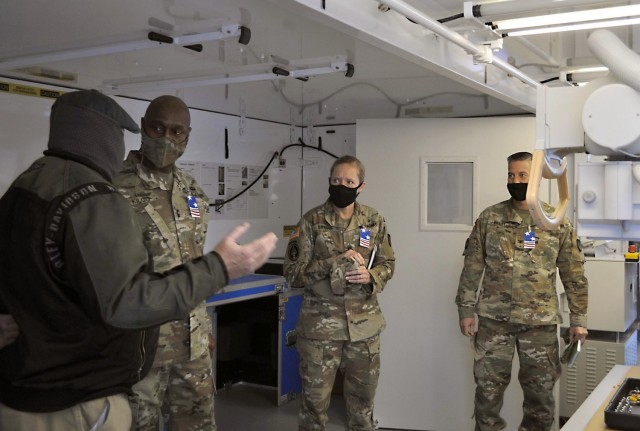 Maj. Gen. Mitchell Kilgo, second from left, commanding general of U.S. Army Communications-Electronics Command, listens to a staff briefing during a Feb. 24 visit to the U.S. Army Medical Materiel Agency’s Medical Maintenance Operations Division...