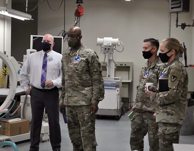 Isaac Newman, left, chief of the U.S. Army Medical Materiel Agency’s Medical Maintenance Operations Division at Tracy, California, briefs leadership from U.S. Army Communications-Electronics Command during a Feb. 24 visit. Pictured with Newman, from left, are Maj. Gen. Mitchell Kilgo, commanding general of CECOM, USAMMA Commander Col. John “Ryan” Bailey and CECOM Command Sgt. Maj. Kristie Brady.