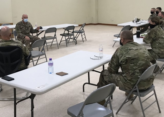 Army Reserve Maj. Nathan Fisher, who deployed with the "Desert Medics" of the 3rd Medical Command (Deployment Support) and serves at the U.S. Central Command microbiologist, briefed Army chaplains March 15, 2021 at Camp Arifjan, Kuwait, on the development history of the three major COVID-19 vaccines and answered their questions. Fisher said, "I wanted to make myself available, so they had the facts surrounding the moral question." (U.S. Army photo by Staff Sgt. Neil W. McCabe)