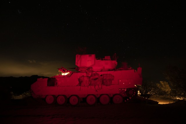 U.S. Army forward observers assigned to the 2nd Battalion, 3rd Field Artillery Regiment, 1st Armored Brigade Combat Team, 1st Armored Division, use their M2 Bradley during a night fire exercise at the Dona Ana Range Complex, NM, March 8, 2021. The...