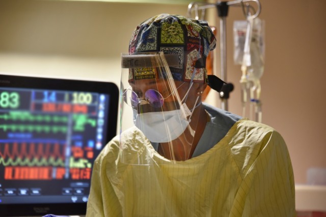 U.S. Army Reserve Capt. Tanisha Nagel, a registered nurse with U.S. Army Reserve Urban Augmentation Medical Task Force 328-1 assigned to support Yuma Regional Medical Center in Yuma, Ariz., works at the bedside of a COVID patient and talks with...