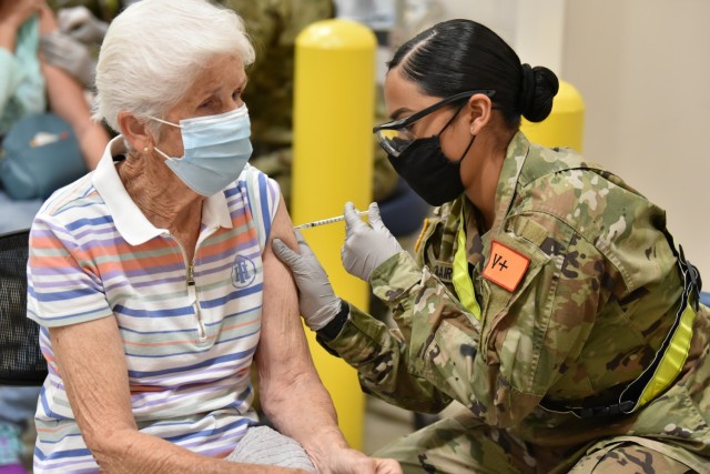68C Practical Nursing Specialist student PV2 Ariel Muraira, assigned to the 264th Medical Battalion, 32nd Medical Brigade, MEDCoE, is assisting the Brooke Army Medical Center by administering the COVID-19 vaccine to a patient. Along with other 68C...