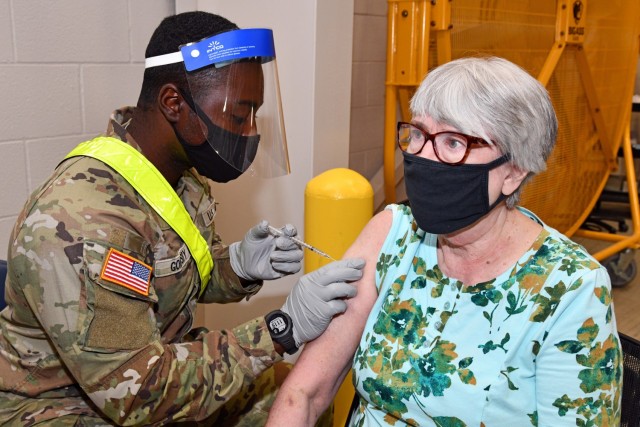 Pfc. Taegan Goldsby, a 68C Practical Nursing Specialist student assigned to the 264th Medical Battalion, 32nd Medical Brigade, MEDCoE, administers the COVID-19 vaccine to a patient. Pvt. Goldsby completed Phase 1 of his Advanced Individual Training and is assisting the Brooke Army Medical Center inoculating patients.