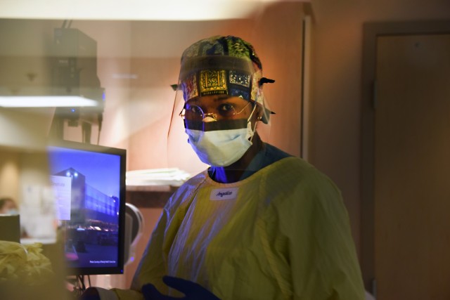 U.S. Army Reserve Capt. Tanisha Nagel, a registered nurse with U.S. Army Reserve Urban Augmentation Medical Task Force 328-1 assigned to support Yuma Regional Medical Center in Yuma, Ariz., inputs her patient’s vitals into the hospital computer...