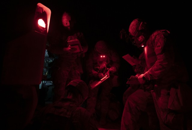 U.S. Army Soldiers assigned to the 2nd Battalion, 3rd Field Artillery Regiment, 1st Armored Brigade Combat Team, 1st Armored Division develop a strategy to fire illumination rounds during a battalion-level artillery qualification exercise, March...