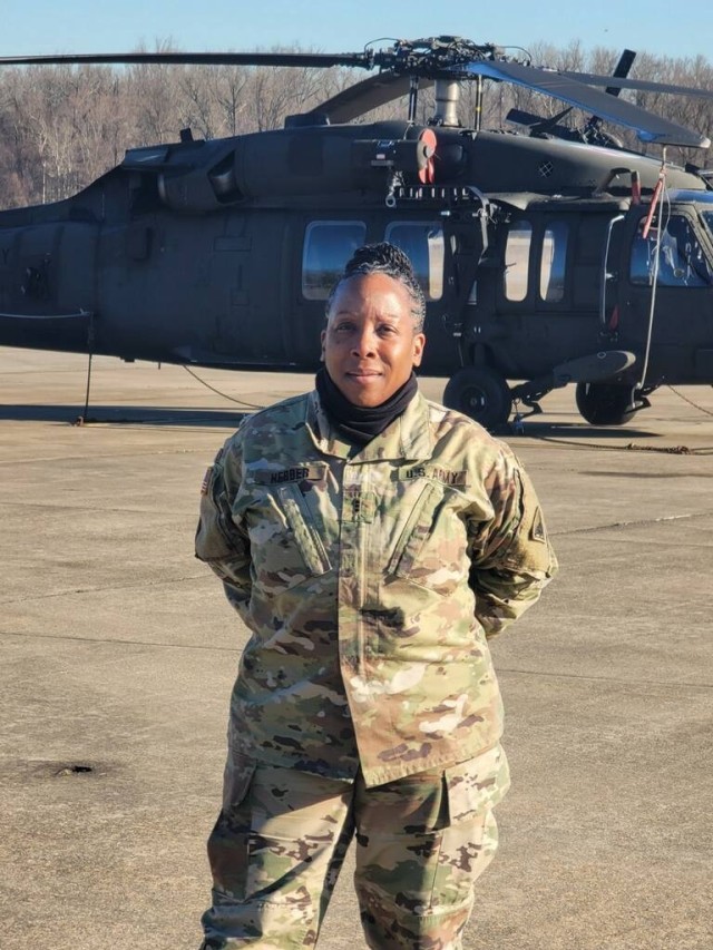 U.S. Army Chief Warrant Officer 4 Melinda Herder, District of Columbia National Guard, stands with helicopters on the flight line at Davison Army Airfield, Ft. Belvoir, Virginia. Herder is the facility maintenance officer at the D.C. National...