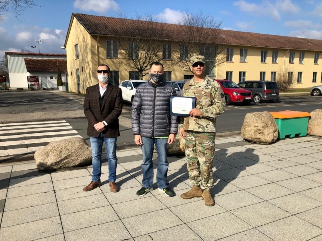WIESBADEN, Germany -- John Parr, information technology specialist, receives his certificate from Col. Mario Washington, garrison commander, Command Sgt. Maj. Christopher Truchon and Scott Mowry, deputy to the garrison commander, for outstanding...