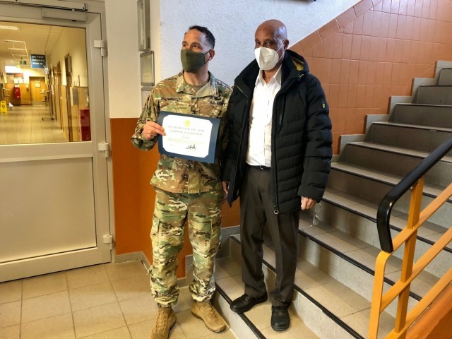 WIESBADEN, Germany -- Salih Abdu, transportation assistant, receives his certificate from Col. Mario Washington, garrison commander, Command Sgt. Maj. Christopher Truchon and Scott Mowry, deputy to the garrison commander, for outstanding customer...