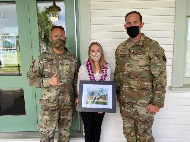 402nd commander Col. Anthony Walters and 402nd Command Sgt. Maj. Adam Lepley presented Arianna Livingston with a photograph of the brigade headquarters in recognition of the great work she has done for the 402nd.