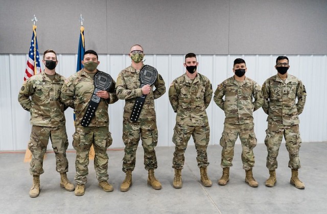 Competitors of the 2021 Kansas Army National Guard Best Warrior Competition pose for a group photo Mar. 21 in Salina, Kansas. From left to right, Sgt. Anthony Bien, 635th Regional Support Group; Sgt. Andrew Gonzales, 1st Battalion, 635th Armor Regiment; Spc. Nikolas Decker, 2nd Battalion, 130th Field Artillery; Pfc. Cooper Ross, 130th Field Artillery Brigade; Pfc. Christian Radabaugh, 1st Battalion, 635th Armor Regiment; and Spc. Sai Chadalawada, 635th Regional Support Group.