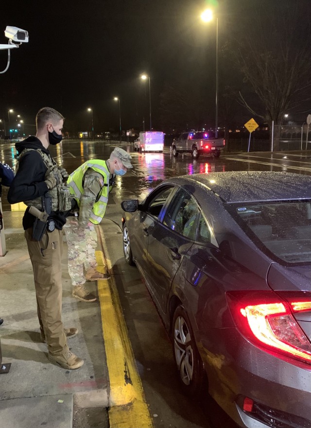 Specialist Jaxon Wright, 163rd Military Police Detachment, 716th Military Police Battalion, speaks with a driver March 17 at a sobriety checkpoint on Fort Campbell. Also pictured is Investigator Avery Neitzel, 163rd MP Co. According to the...