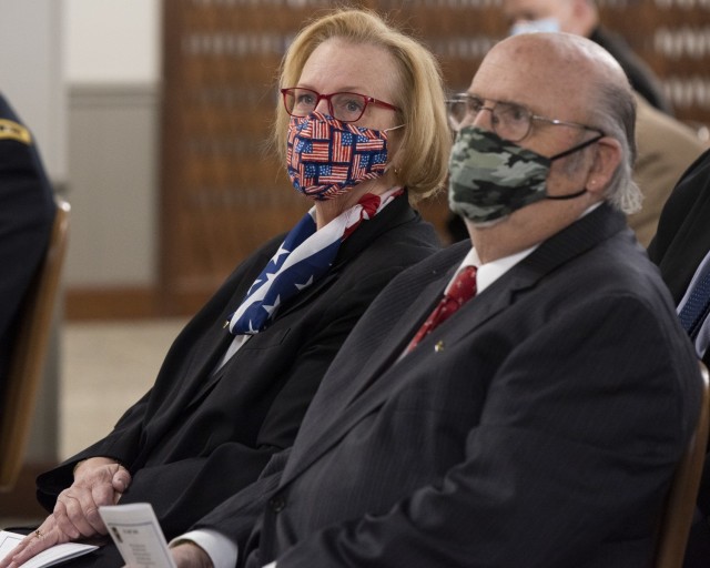 K Krewer, chief counsel, U.S. Army Materiel Command Legal Center-Rock Island Arsenal, sits next to her husband, Tom Flaig, during her retirement ceremony held at Rock Island Arsenal, Illinois, March 26. (Photo by Linda Lambiotte, ASC Public Affairs)