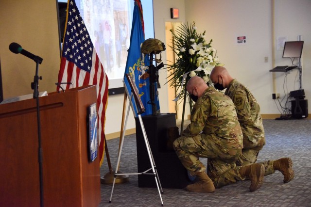 Two soldiers from the Presidio of Monterey’s 229th Military Intelligence Battalion kneel during a memorial service for Spc. Ryan Tasso March 11. Tasso, had graduated from the Russian Defense Language Institute Foreign Language Program in...