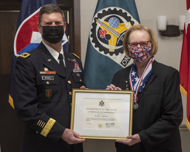 K Krewer, chief counsel, U.S. Army Materiel Command Legal Center-Rock Island Arsenal, was presented her certificate of retirement by Maj. Gen. Daniel Mitchell, commanding general, U.S. Army Sustainment Command, during a retirement ceremony held in her honor at Rock Island Arsenal, Illinois, March 26. (Photo by Linda Lambiotte, ASC Public Affairs)