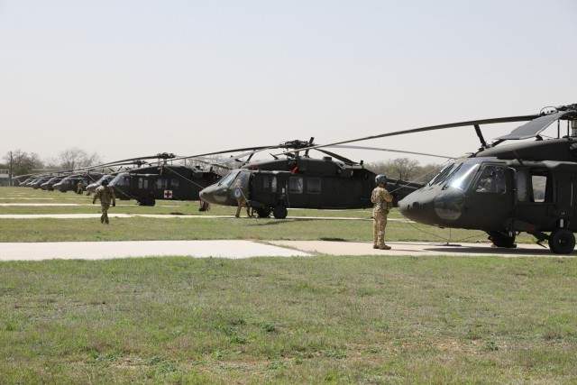 UH-60 Black Hawk helicopters from Task Force Phoenix are parked at Longhorn Auxiliary Landing Strip during pre-deployment training, March 17, 2021 at North Fort Hood, Texas. (U.S. Army National Guard photo by Sgt. 1st Class Ryan Sheldon)