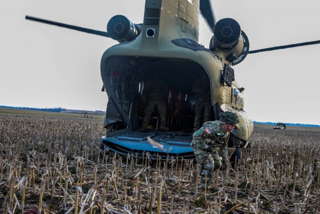 U.S. Army Lt. Col. Jeffrey Farmer, commander, 1st Battalion, 506th Infantry Regiment "Red Currahee", 1st Brigade Combat Team "Bastogne", 101st Airborne Division (Air Assault), exits the rear of a CH-47 Chinook helicopter at a landing zone during Toccoa Tough II, a leadership professional development course March 8-12, on post. (U.S. Army photo by Sgt. Lynnwood Thomas)