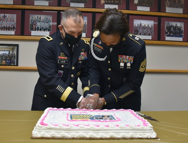 Brig. Gen. Michael Lalor, commander of U.S. Army Medical Logistics Command, and AMLC Sgt. Maj. Danyell Walters cut a cake to celebrate Women’s History Month following a commemoration event March 26 at Fort Detrick, Maryland.