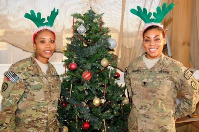 U.S. Army Sgt. 1st Class (then-Sgt.) Dana Mister, left, an inspector general non-commissioned officer in charge with the 1st Theater Sustainment Command at Fort Knox, Kentucky, stands with Spc. Teyla Brown during the holidays on deployment to Afghanistan in 2012. (U.S. Army photo courtesy of Sgt. 1st Class Dana Mister)