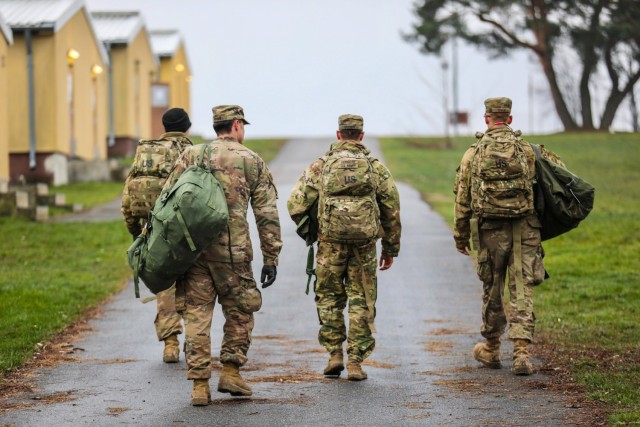 U.S. Army Soldiers from the 91st Brigade Engineer Battalion, 1st Armored Brigade Combat Team, 1st Cavalry Division carry their duffel bags to their temporary barracks at Camp Aachen in Grafenwoehr, Germany, Dec. 19, 2018. This is the last stop of...